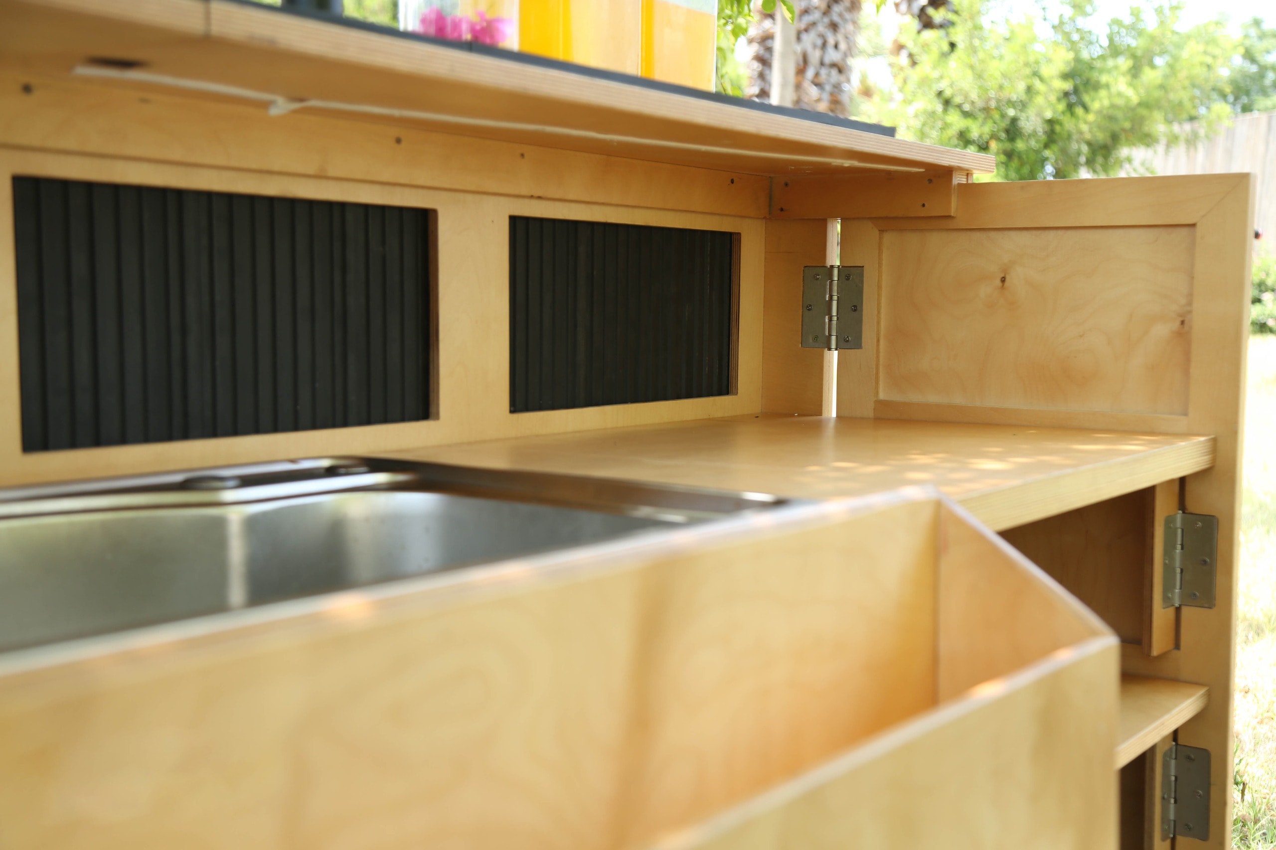 Close-up detail of the bar's built-in sink and cutting board work surface